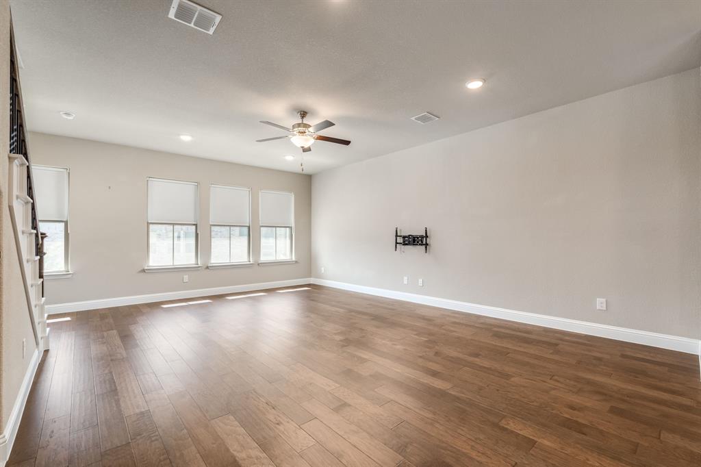 801 Cassandra Court Euless, TX 76040 - Photo 14 of 36 wooden floor in an empty room with a window