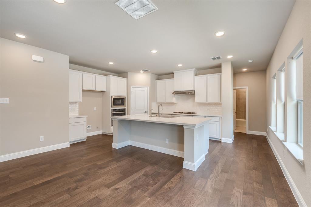 801 Cassandra Court Euless, TX 76040 - Photo 17 of 36 a kitchen with stainless steel appliances refrigerator sink and cabinets