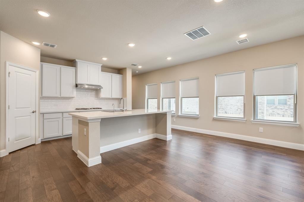 801 Cassandra Court Euless, TX 76040 - Photo 18 of 36 a kitchen with white cabinets and window