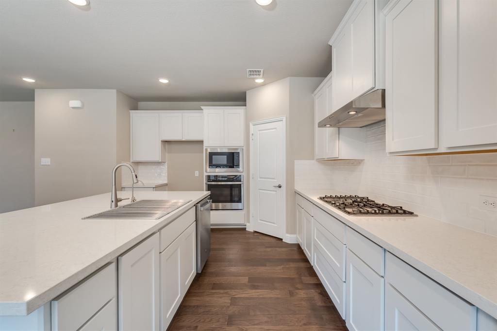 801 Cassandra Court Euless, TX 76040 - Photo 19 of 36 a kitchen with stainless steel appliances a sink stove and cabinets