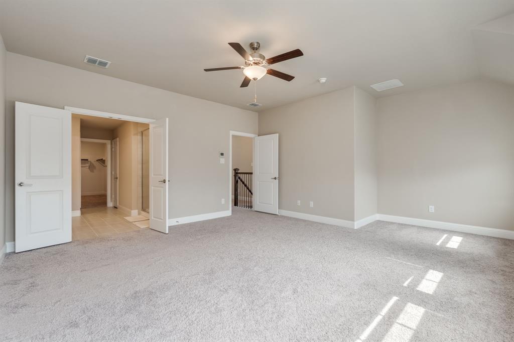 801 Cassandra Court Euless, TX 76040 - Photo 28 of 36 an empty room with closet and a ceiling fan