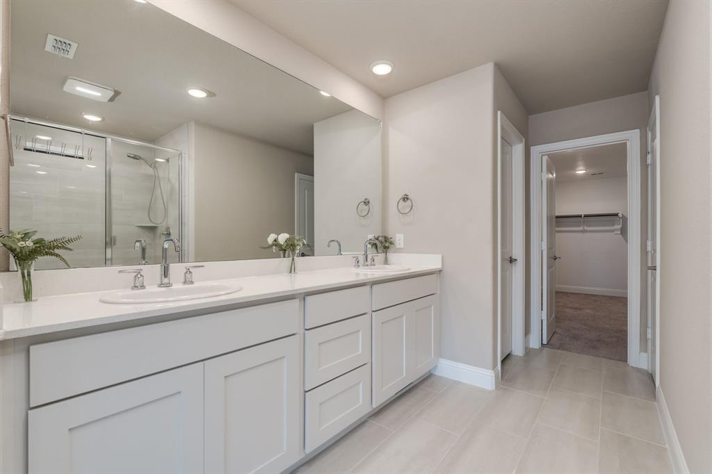 801 Cassandra Court Euless, TX 76040 - Photo 30 of 36 a bathroom with double sink and a mirror