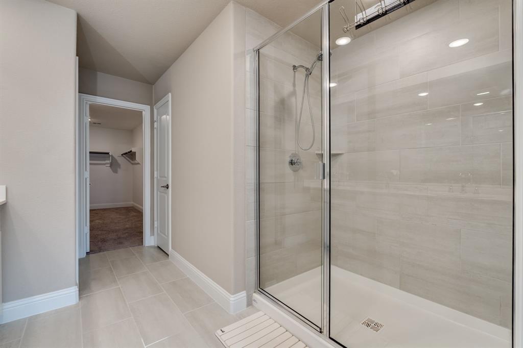 801 Cassandra Court Euless, TX 76040 - Photo 31 of 36 a bathroom with a glass shower door