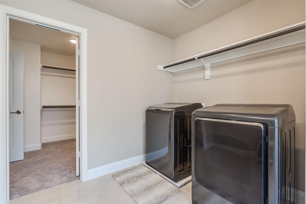 801 Cassandra Court Euless, TX 76040 - Photo 33 of 36 a utility room with washer and dryer