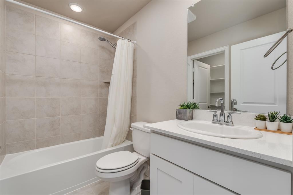 801 Cassandra Court Euless, TX 76040 - Photo 35 of 36 a bathroom with a sink a toilet and a mirror