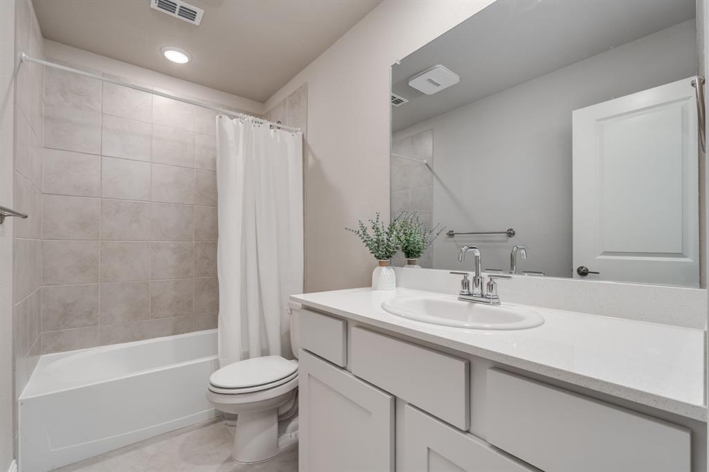 801 Cassandra Court Euless, TX 76040 - Photo 7 of 36 a bathroom with a sink a toilet and shower