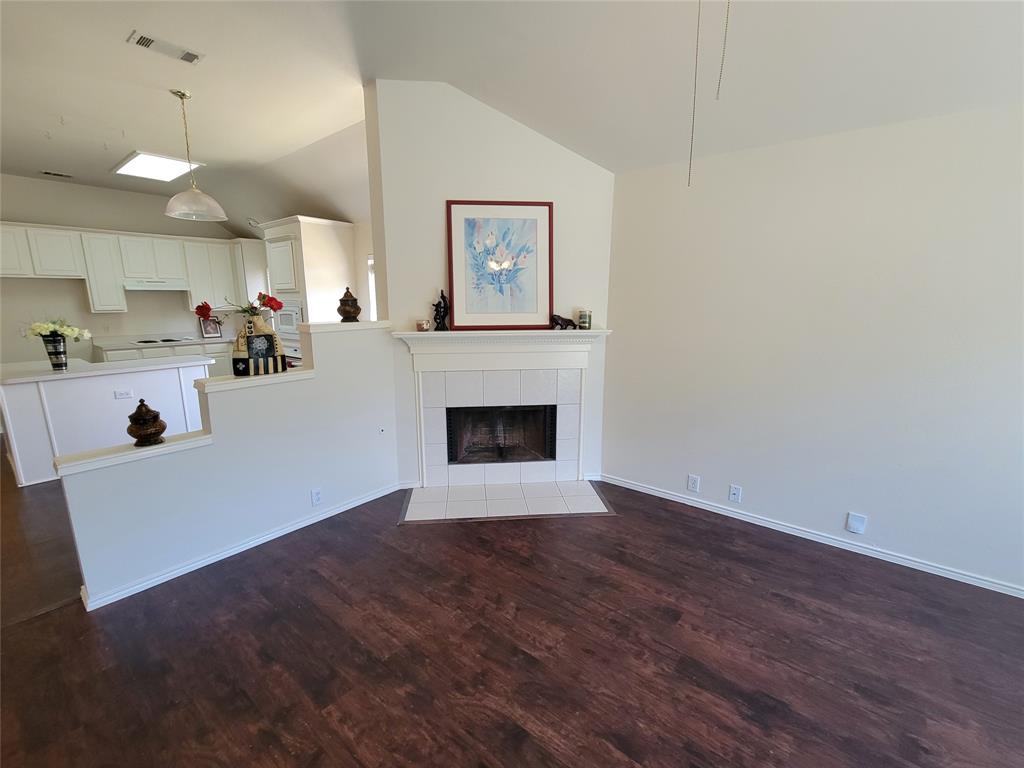 2913 Rush Creek Road McKinney, TX 75072 - Photo 2 of 32 Living room with a fireplace, dark wood-style floors, ceiling fan, and lofted ceiling