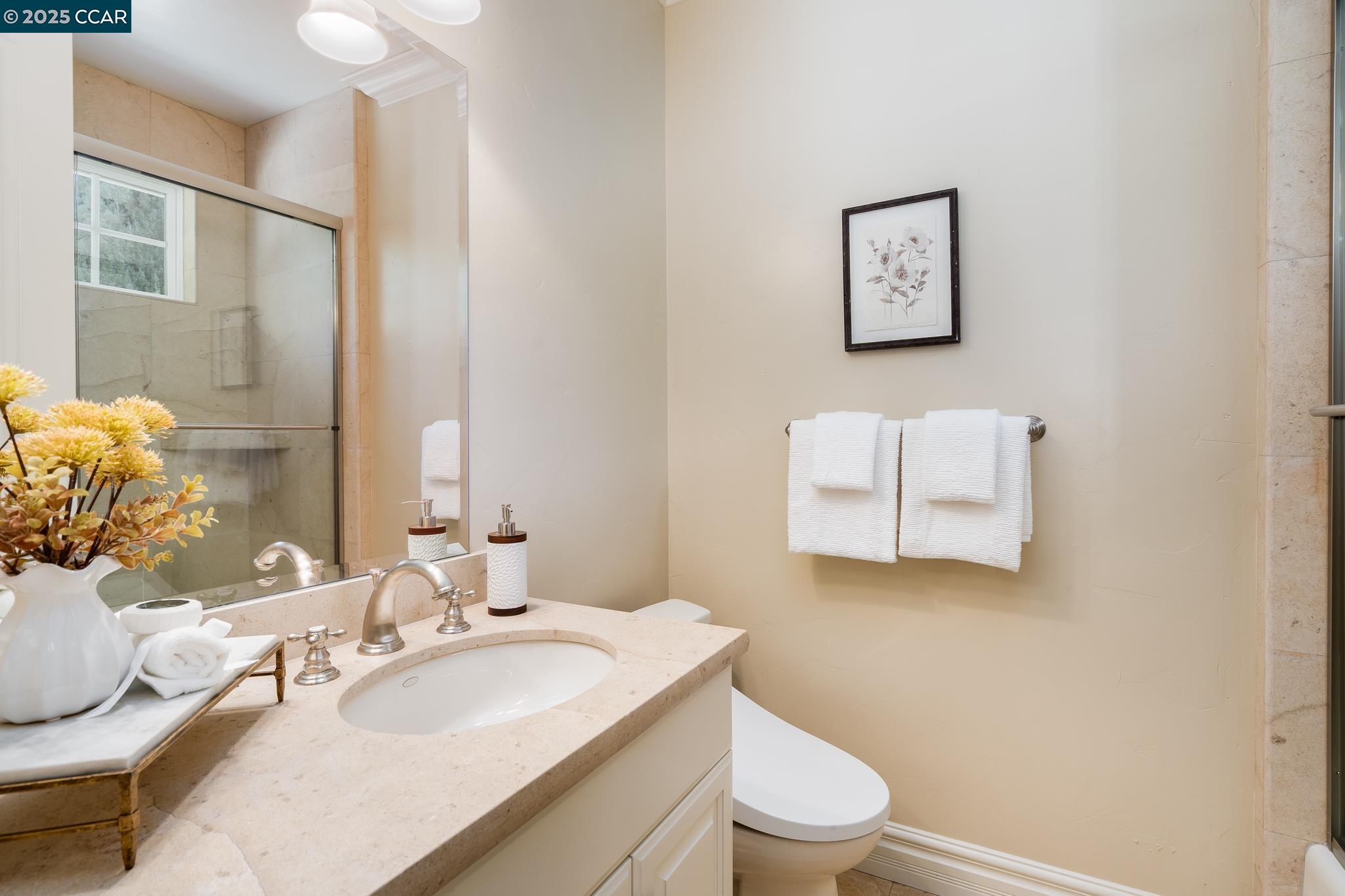 471 El Rio Danville, CA 94526 - Photo 29 of 51 a bathroom with a granite countertop toilet sink and mirror