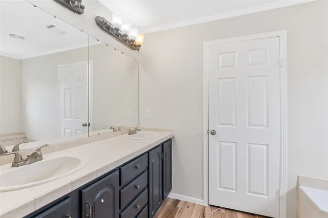 a bathroom with a double vanity sink and a mirror