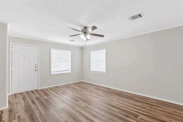 wooden floor in an empty room with a window