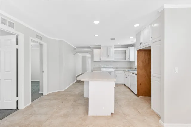 a kitchen with a sink stainless steel appliances and white cabinets