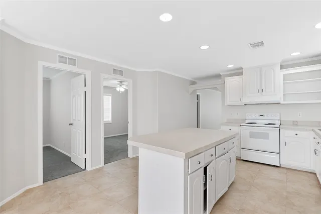 a utility room with cabinets washer and dryer