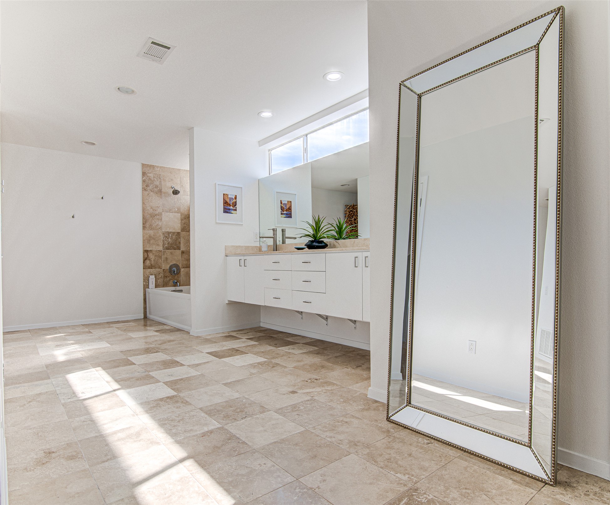 9707 Timber Ridge Pass Austin, TX 78733 - Photo 10 of 18 Gleaming tile floors and high-set windows illuminate this spacious bathroom with floating cabinetry.