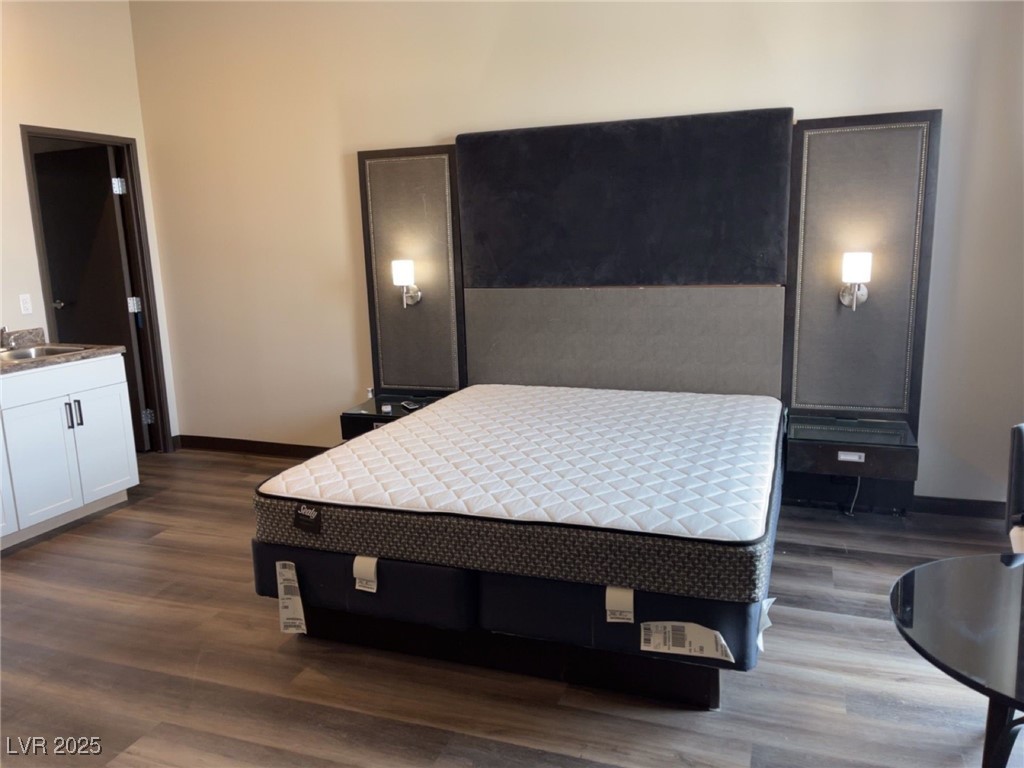 107 South Water Street, Unit 413 Henderson, NV 89015 - Photo 5 of 6 Bedroom featuring dark wood-type flooring