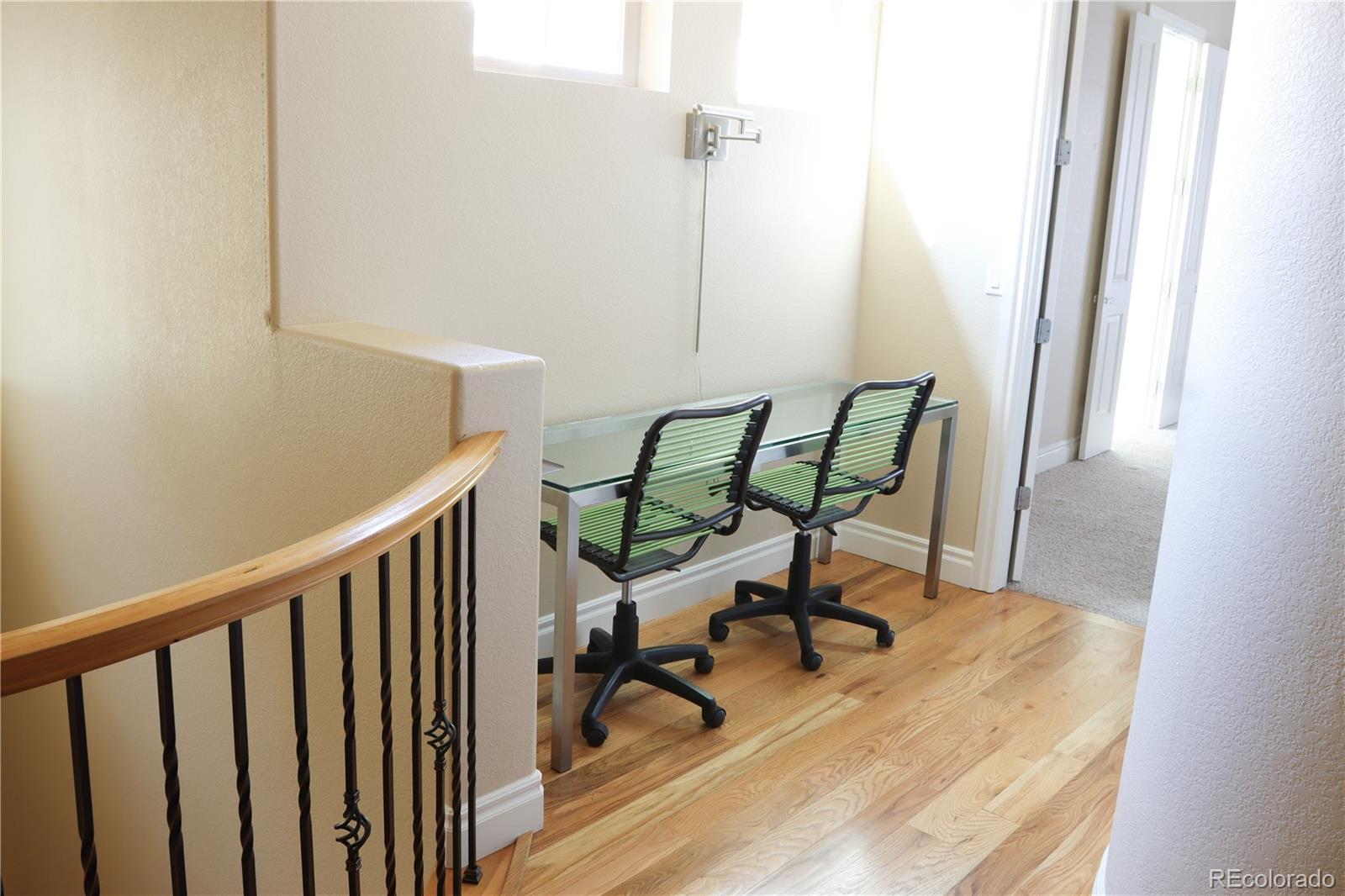 9242 Ridgegate Parkway Lone Tree, CO 80124 - Photo 12 of 28 a view of a hallway with wooden floor and a table