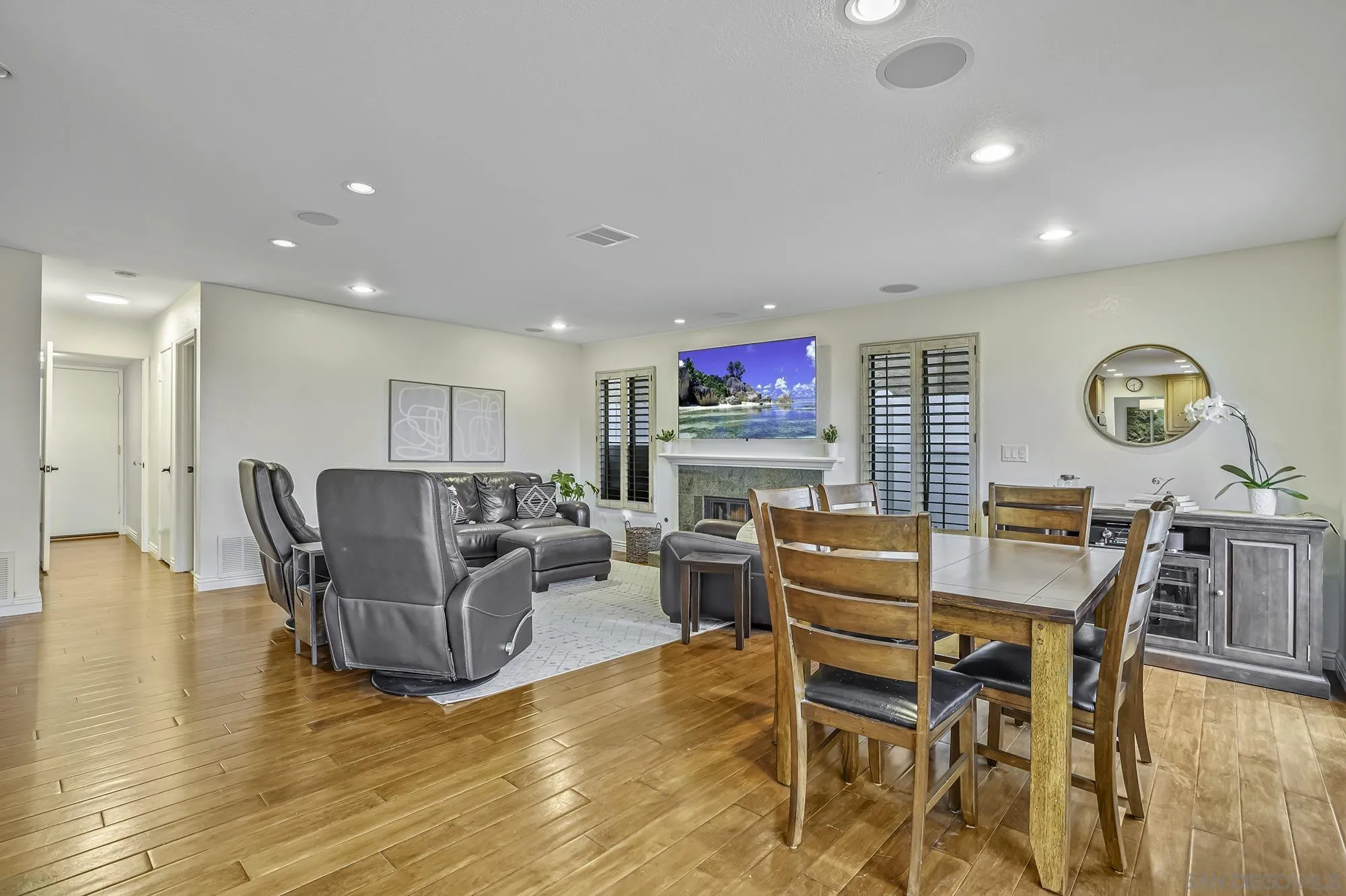 1848 Avenida Mimosa Encinitas, CA 92024 - Photo 8 of 35 a living room with furniture a fireplace and a kitchen view