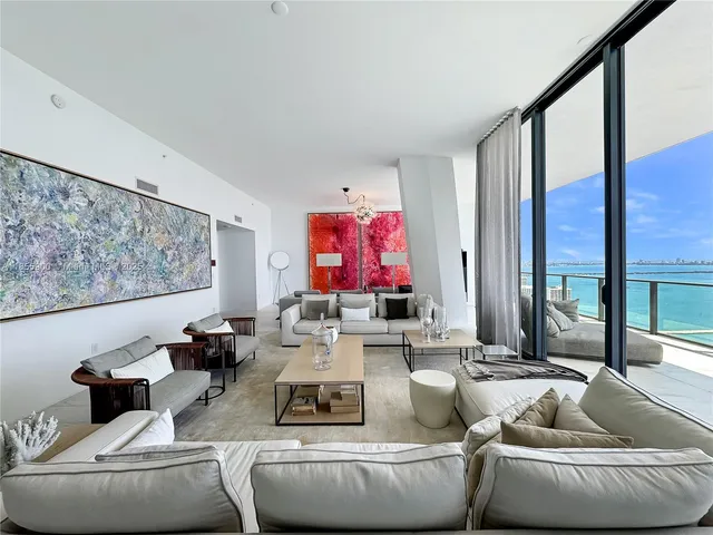 a view of a balcony with couches and wooden floor