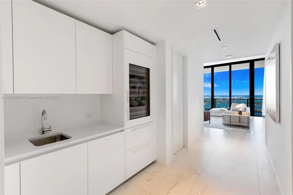 a kitchen with stainless steel appliances a stove two chairs and a refrigerator