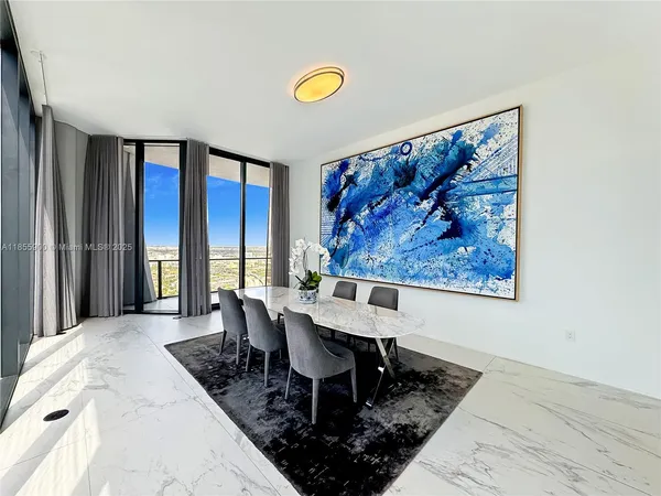 a living room with furniture and a painting on the wall