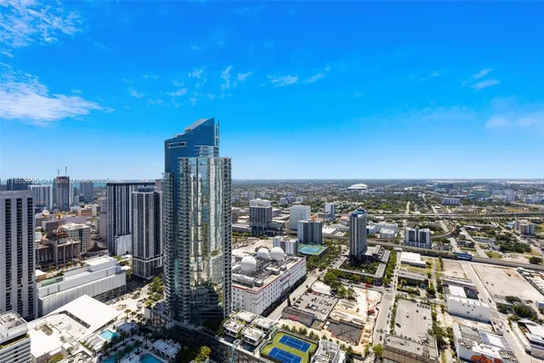 a bathroom with bathtub a double vanity sink and a window