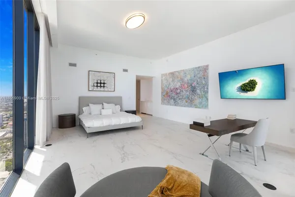 a bedroom with a large bed and a large window