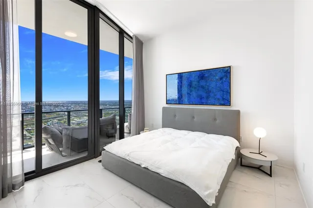 a bedroom with furniture and a window