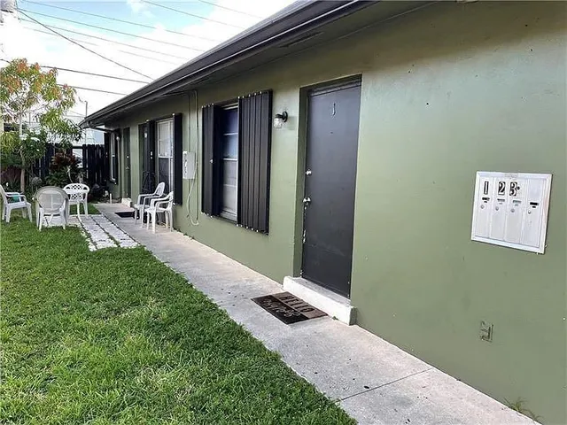 a view of a porch with chairs and backyard