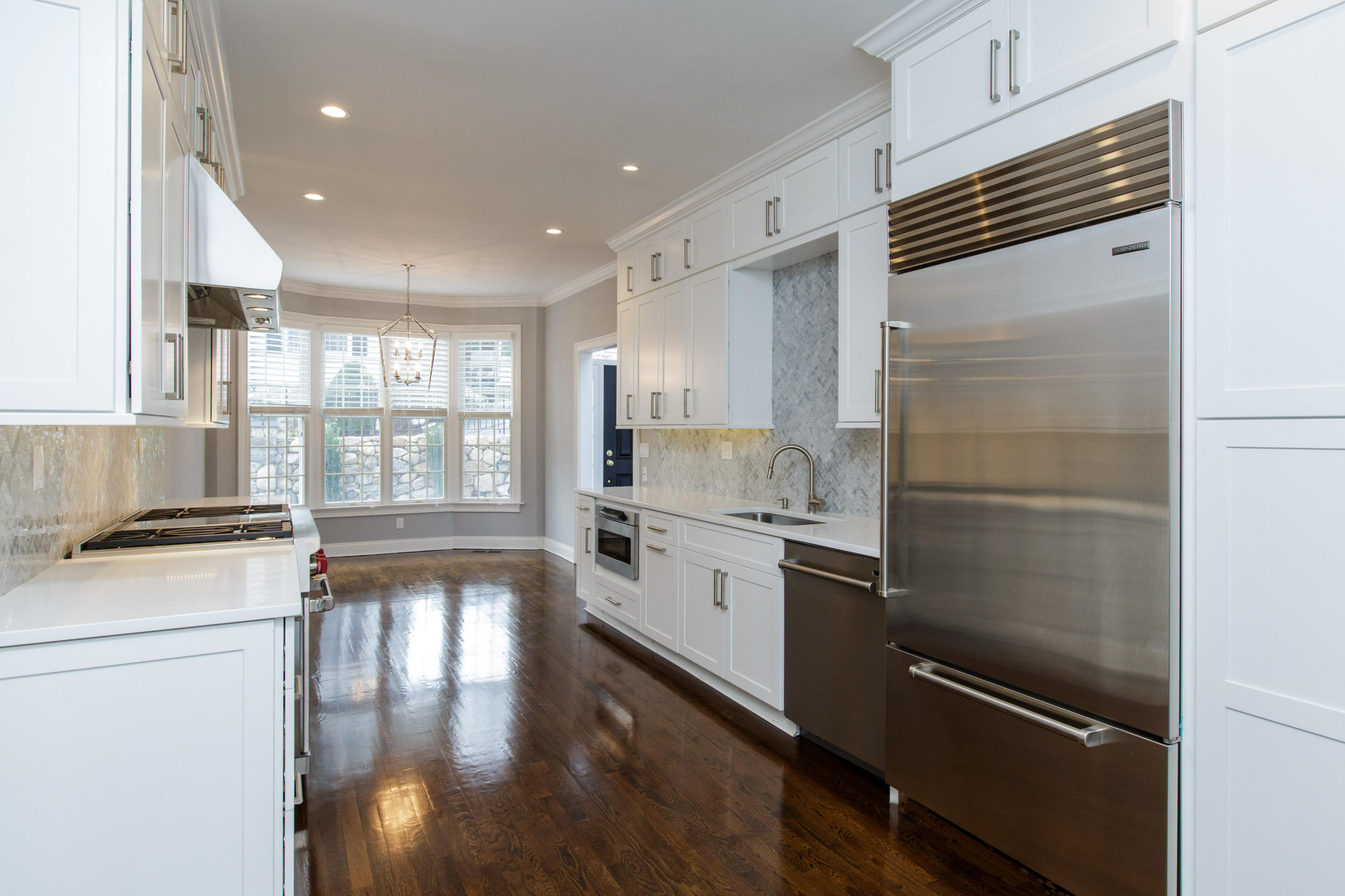 142 Harrison Avenue New Canaan, CT 06840 - Photo 11 of 30 a kitchen with granite countertop stainless steel appliances and wooden cabinets