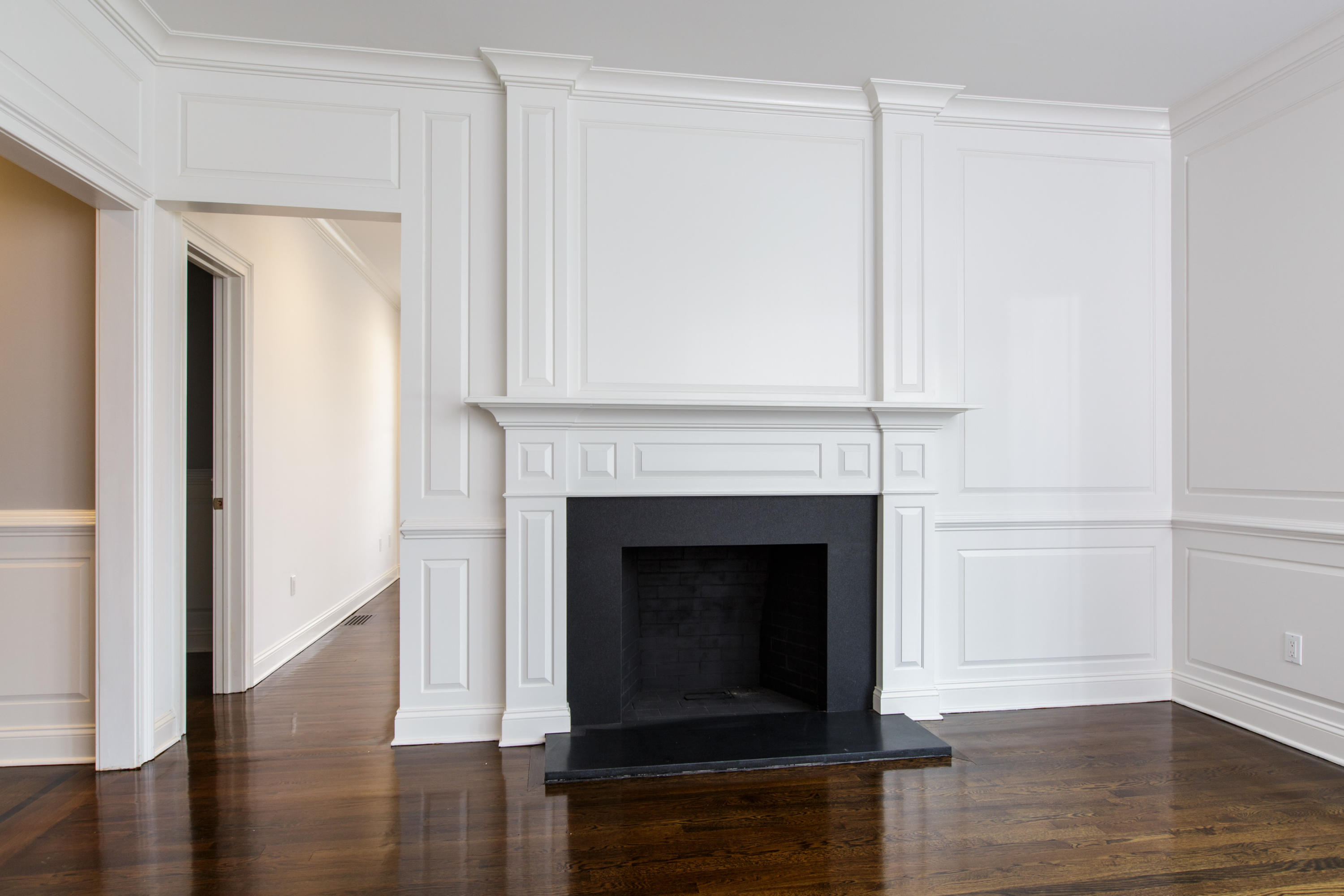 142 Harrison Avenue New Canaan, CT 06840 - Photo 12 of 30 a living room with a fireplace and wooden floor