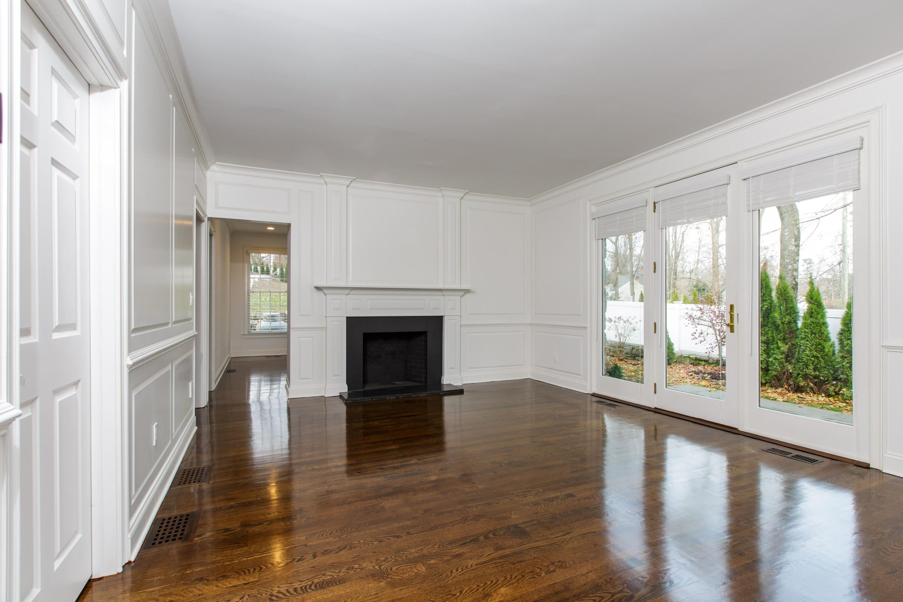 142 Harrison Avenue New Canaan, CT 06840 - Photo 13 of 30 a view of an empty room with wooden floor and a window