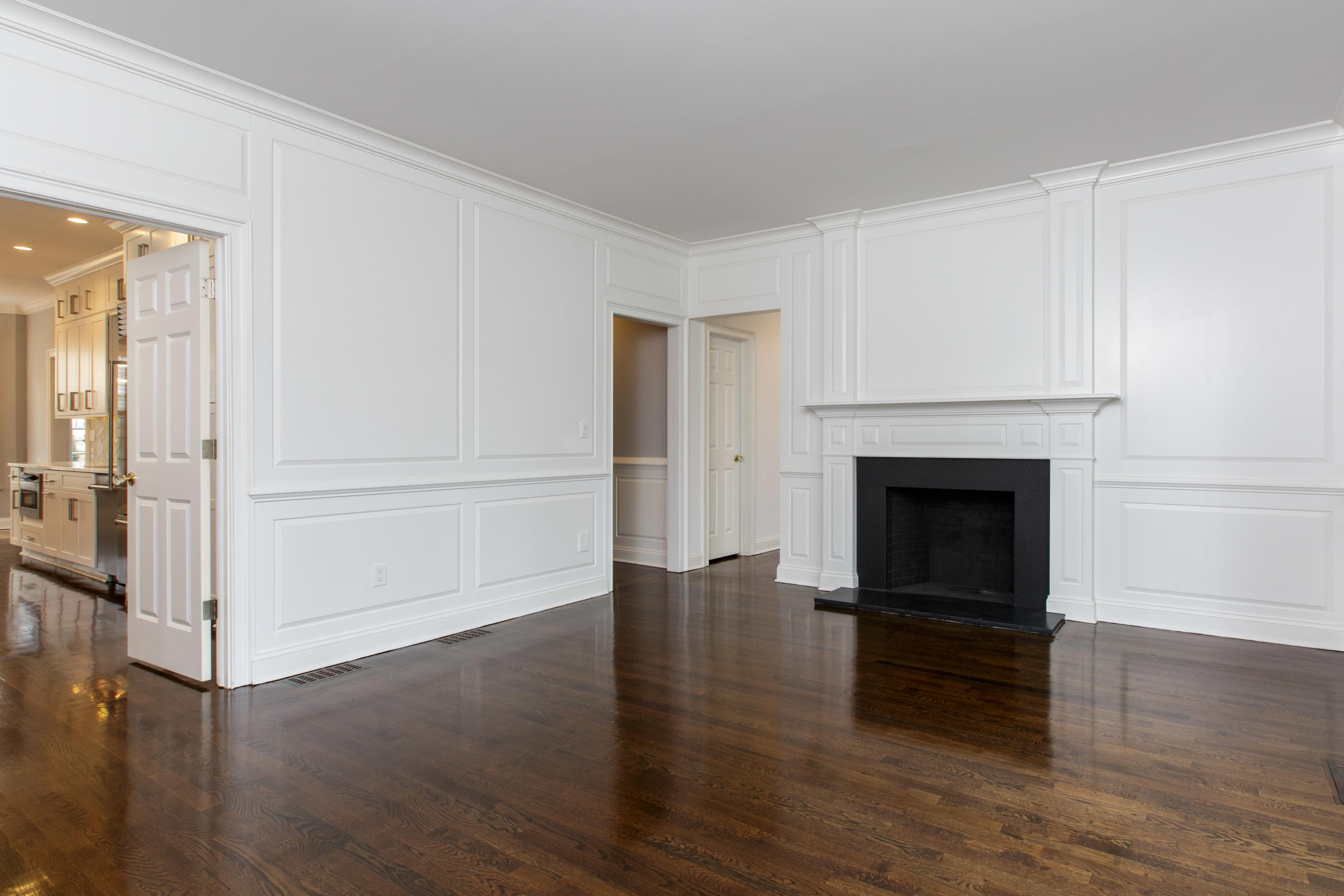 142 Harrison Avenue New Canaan, CT 06840 - Photo 14 of 30 a view of a livingroom with wooden floor and a fireplace