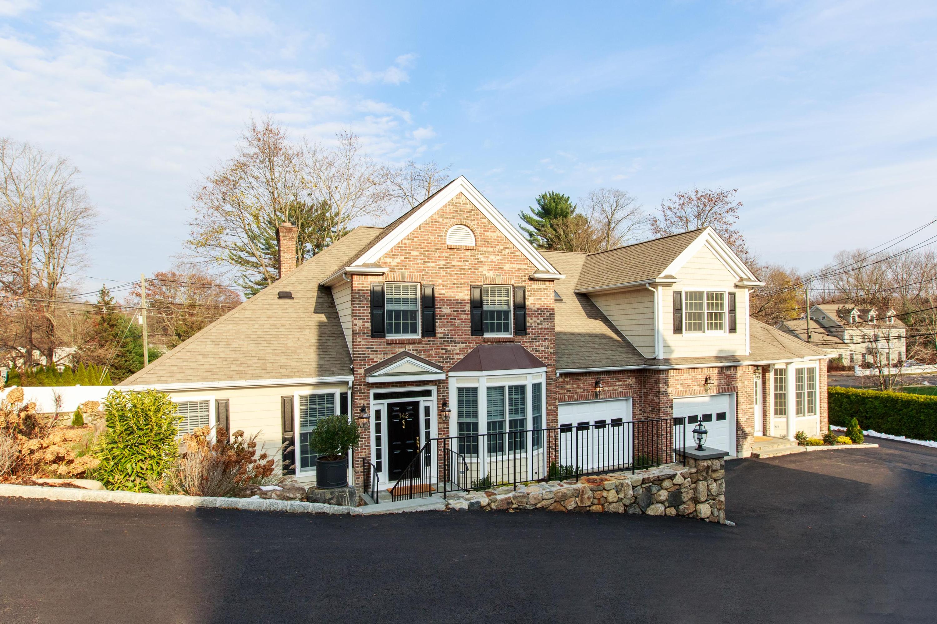 142 Harrison Avenue New Canaan, CT 06840 - Photo 2 of 30 a front view of a house with a street