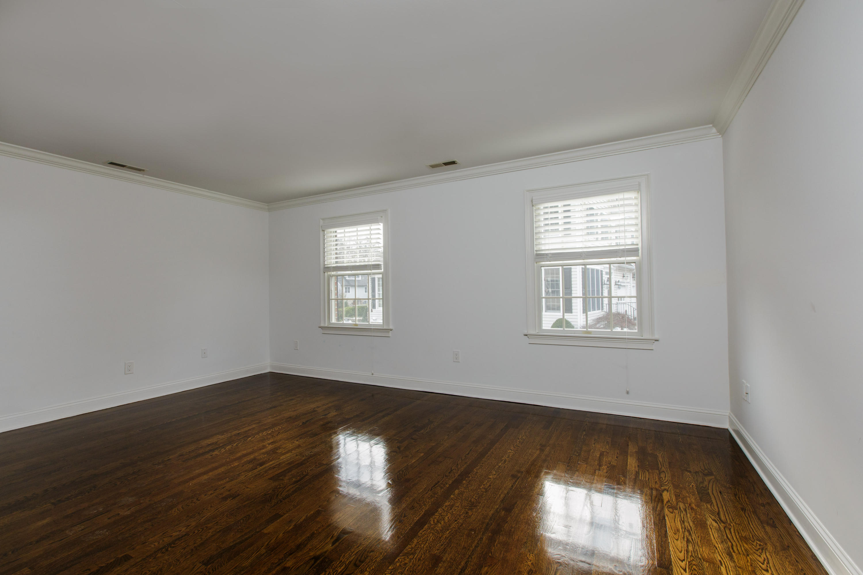 142 Harrison Avenue New Canaan, CT 06840 - Photo 22 of 30 a view of an empty room with wooden floor and a window