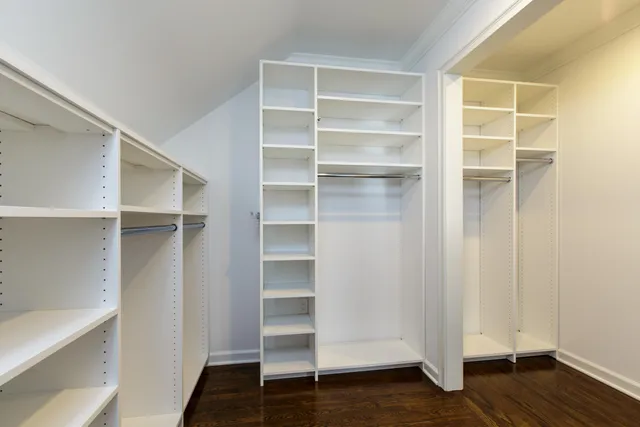 a view of walk in closet with empty racks