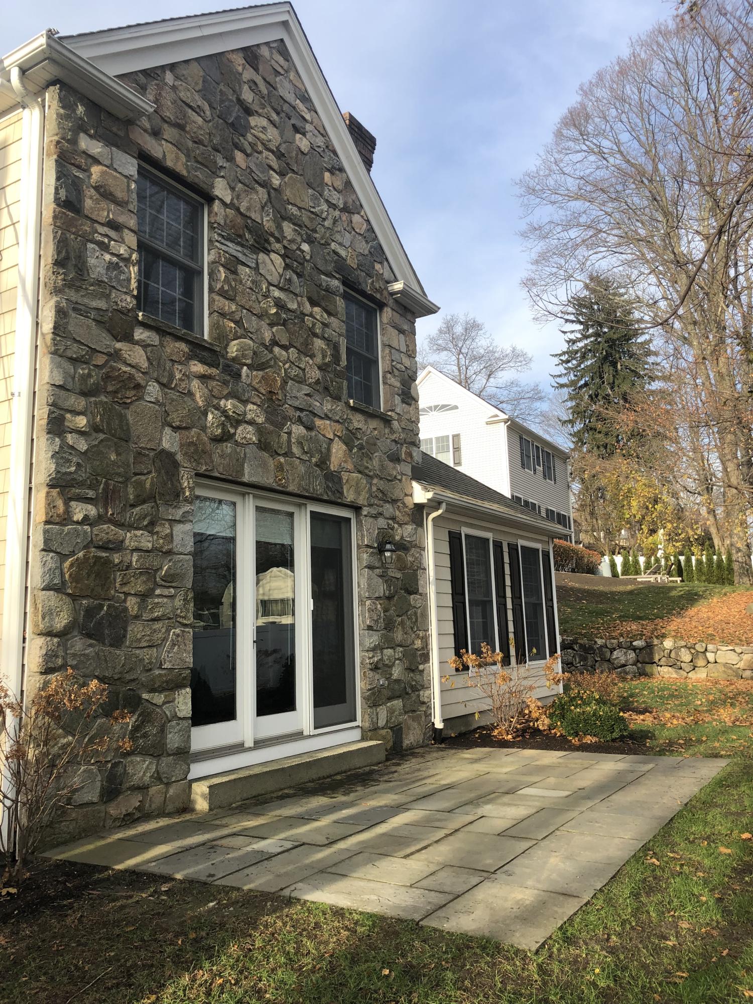 142 Harrison Avenue New Canaan, CT 06840 - Photo 26 of 30 a front view of a house with a yard