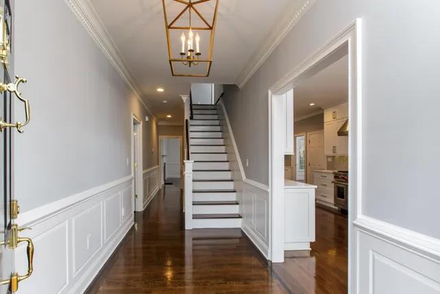 a view of a hallway with wooden floor and staircase
