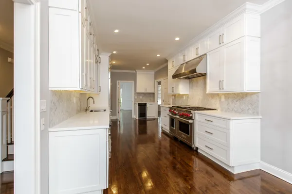 a kitchen with stainless steel appliances kitchen island granite countertop a sink and a stove