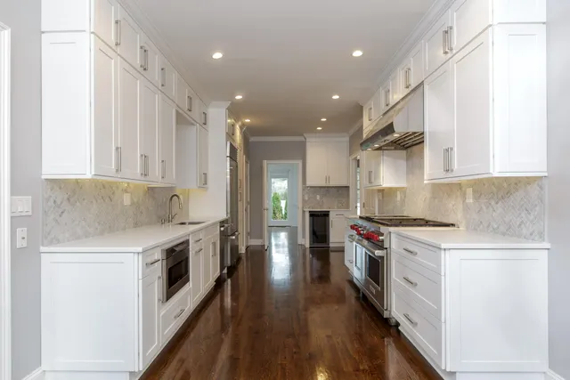 a kitchen with a stove top oven sink and cabinets