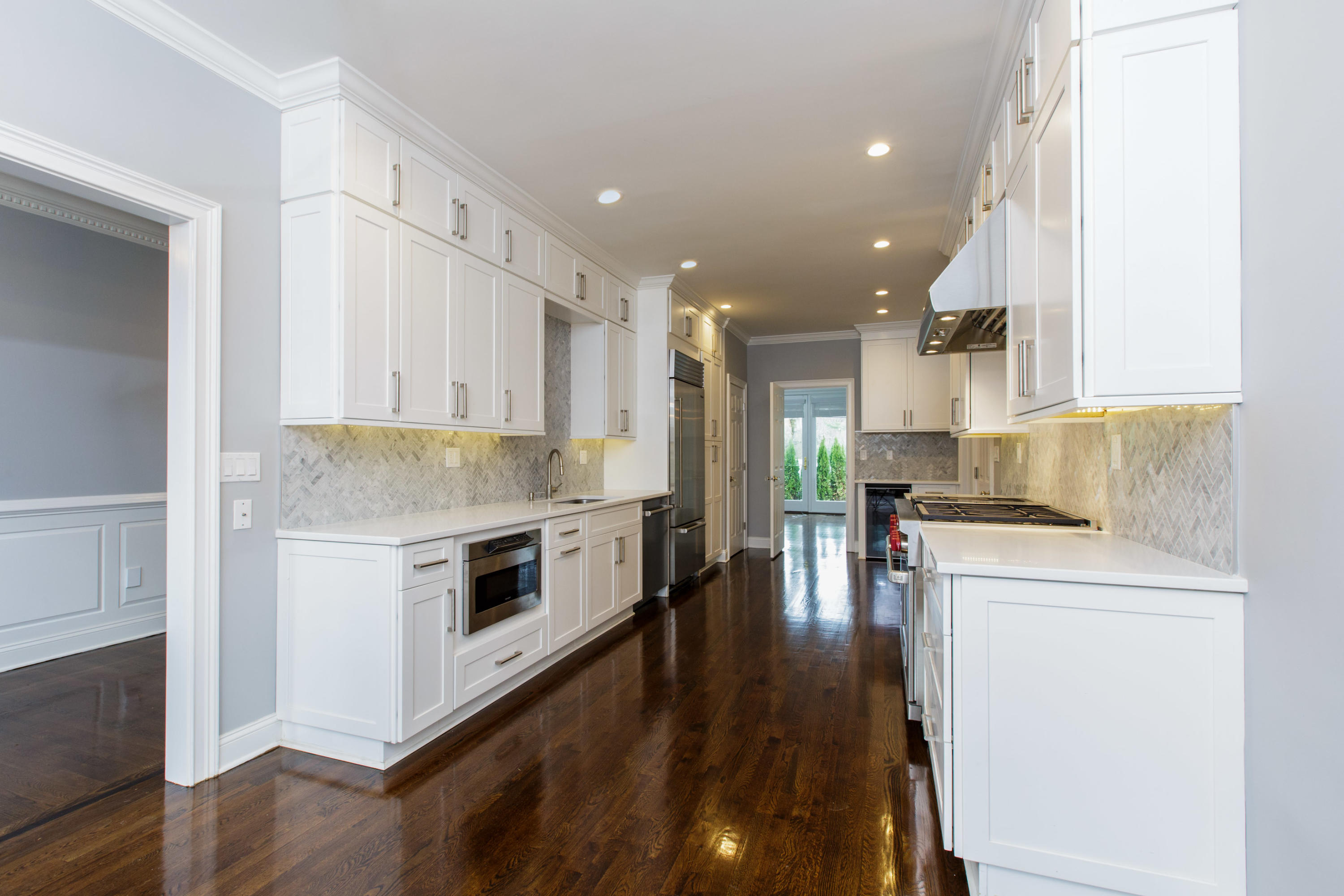 142 Harrison Avenue New Canaan, CT 06840 - Photo 9 of 30 a kitchen with a stove a sink and a refrigerator