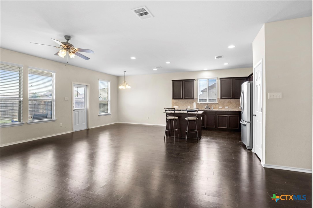 1203 Daffodil Drive Temple, TX 76502 - Photo 13 of 30 a view of a kitchen with microwave and wooden floor