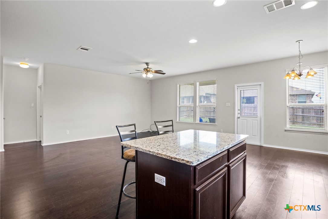 1203 Daffodil Drive Temple, TX 76502 - Photo 15 of 30 a kitchen with a table chairs and wooden floor