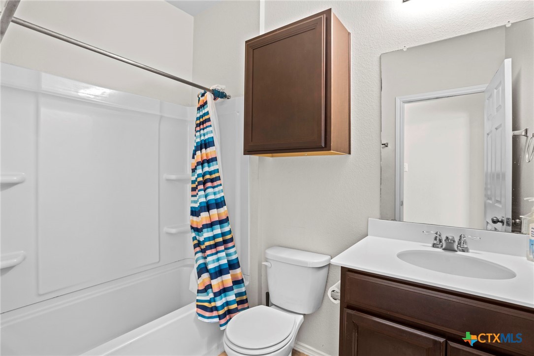 1203 Daffodil Drive Temple, TX 76502 - Photo 19 of 30 a bathroom with a sink mirror vanity and toilet