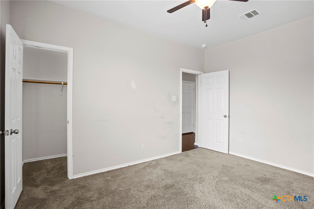 1203 Daffodil Drive Temple, TX 76502 - Photo 20 of 30 an empty room with a ceiling fan and a window