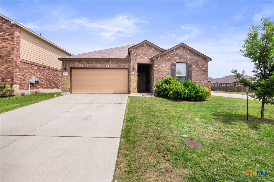 1203 Daffodil Drive Temple, TX 76502 - Photo 2 of 30 a front view of a house with a yard and garage