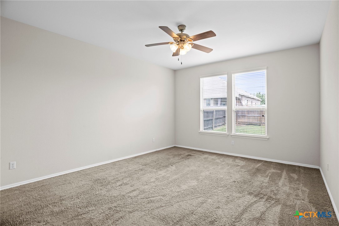 1203 Daffodil Drive Temple, TX 76502 - Photo 21 of 30 an empty room with windows and fan