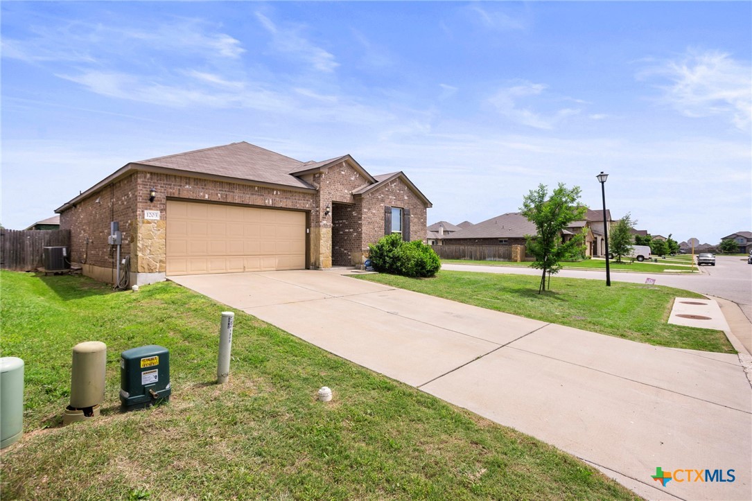 1203 Daffodil Drive Temple, TX 76502 - Photo 3 of 30 a front view of a house with a yard and garage