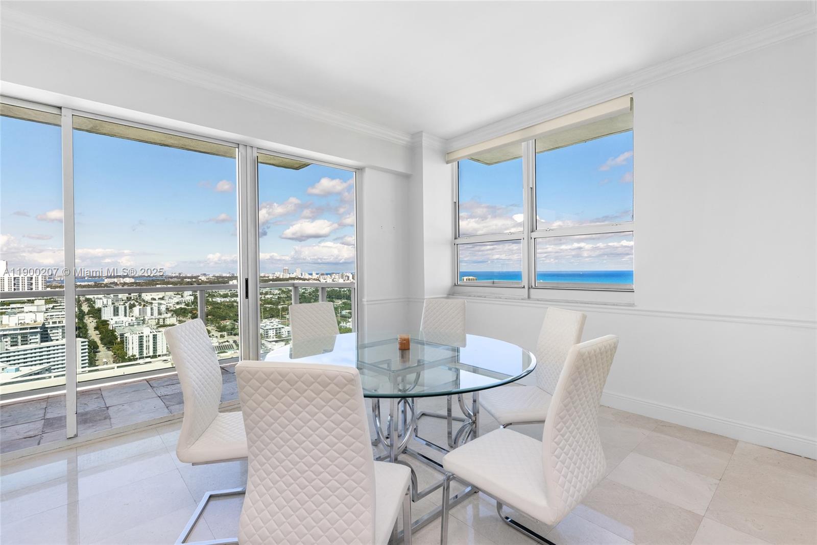 650 West Avenue, Unit PH12 Miami Beach, FL 33139 - Photo 14 of 37 a dining room with furniture large windows and wooden floor