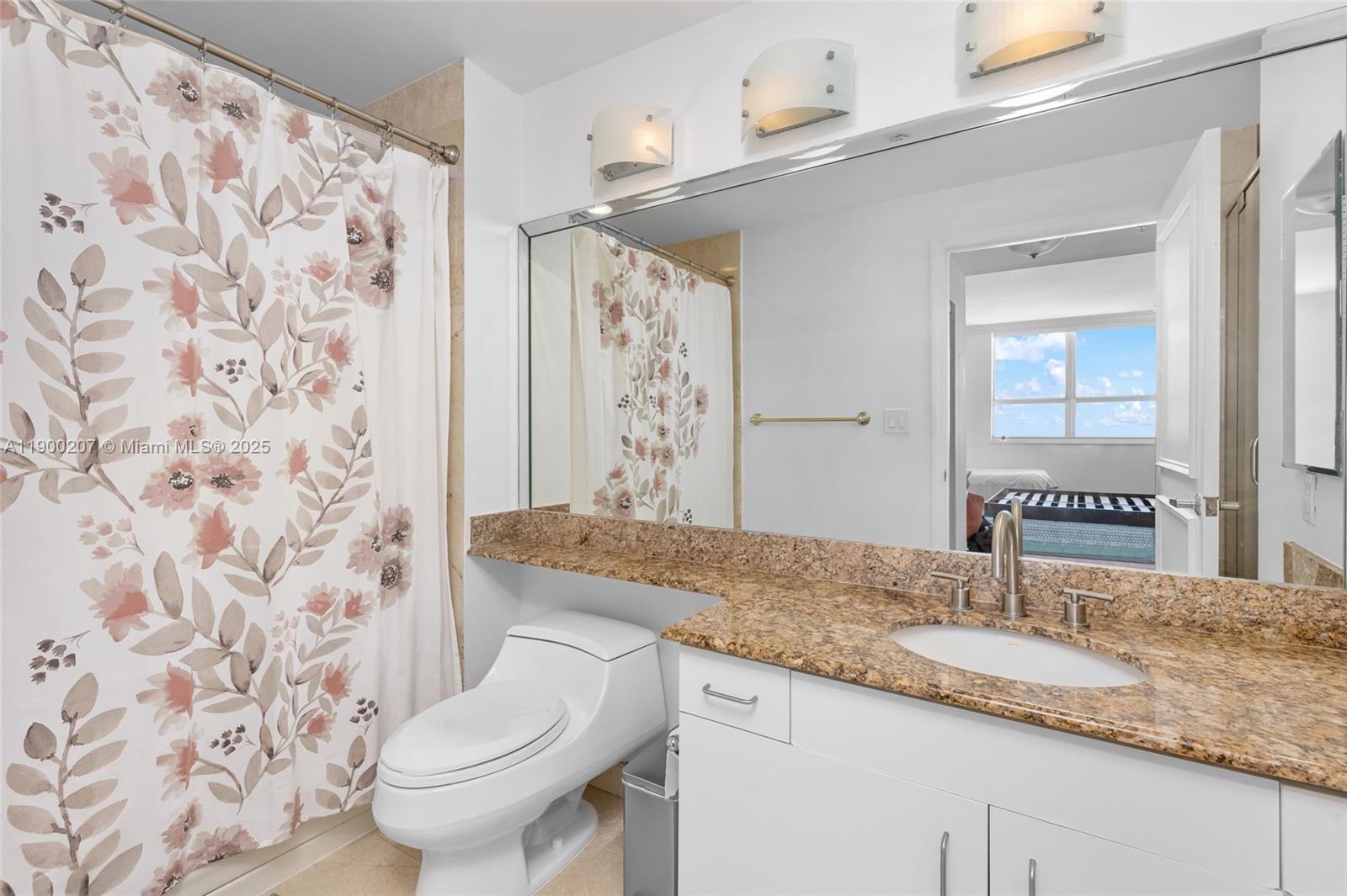 650 West Avenue, Unit PH12 Miami Beach, FL 33139 - Photo 21 of 37 a bathroom with a granite countertop sink and a mirror