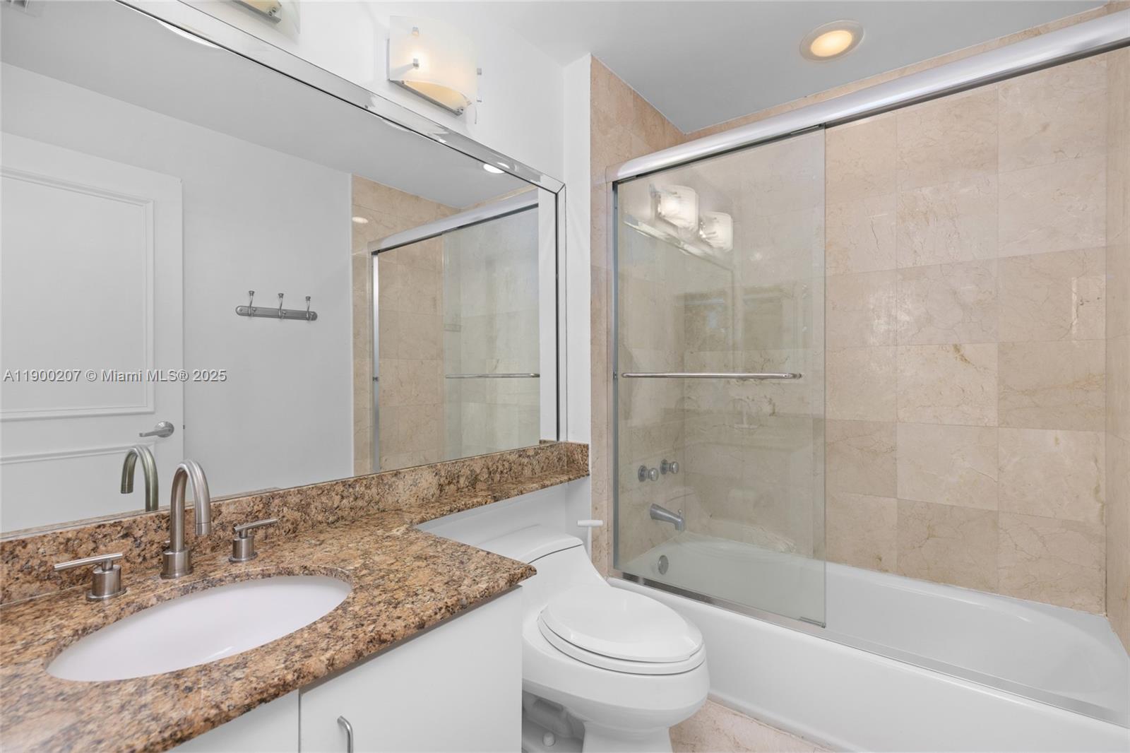 650 West Avenue, Unit PH12 Miami Beach, FL 33139 - Photo 23 of 37 a bathroom with a granite countertop tub shower sink and toilet