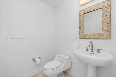 a bathroom with a toilet a sink and mirror